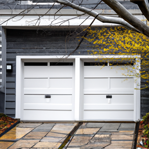 Modern steel garage door on a suburban Sudbury driveway with light frost and overcast winter lighting.