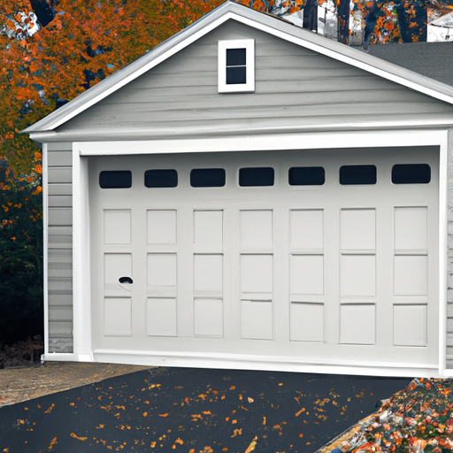 Closed residential garage door with intact bottom seal and autumn leaves on driveway in a Sudbury, MA neighborhood.